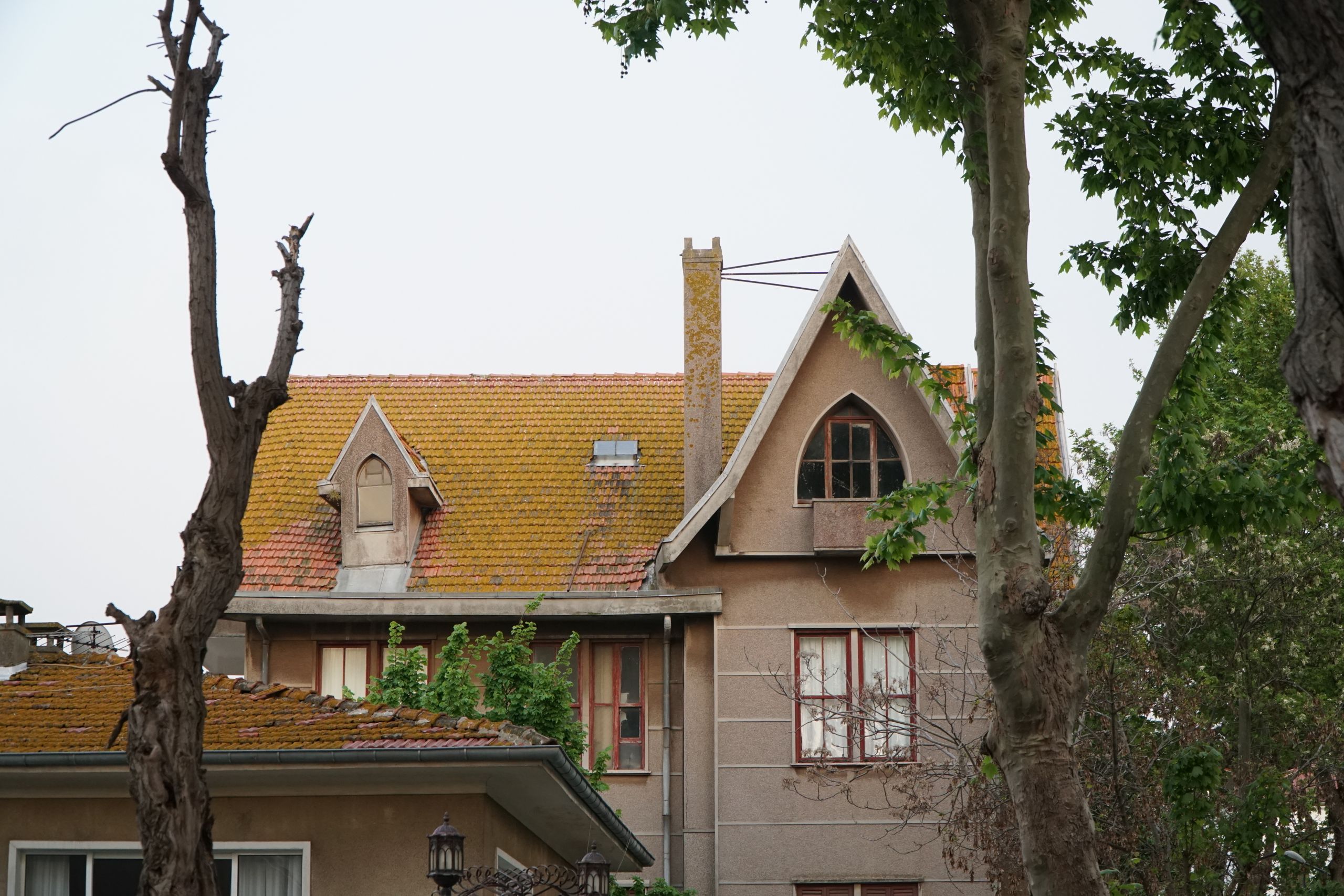 Residential house with clearly visible steep roof pitch showing traditional gable roof construction
