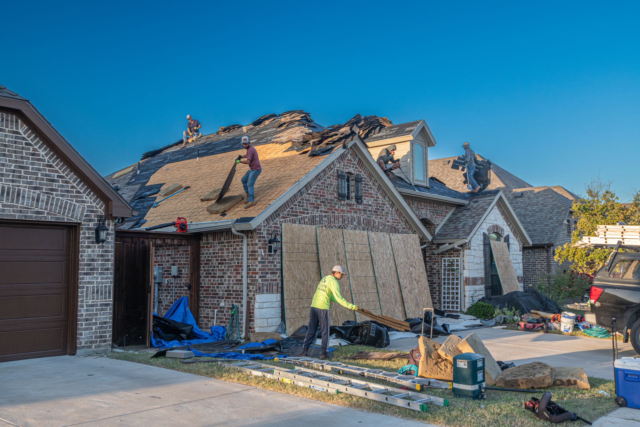 Close up view of architectural dimensional shingles on a residential roof showing textured layered appearance